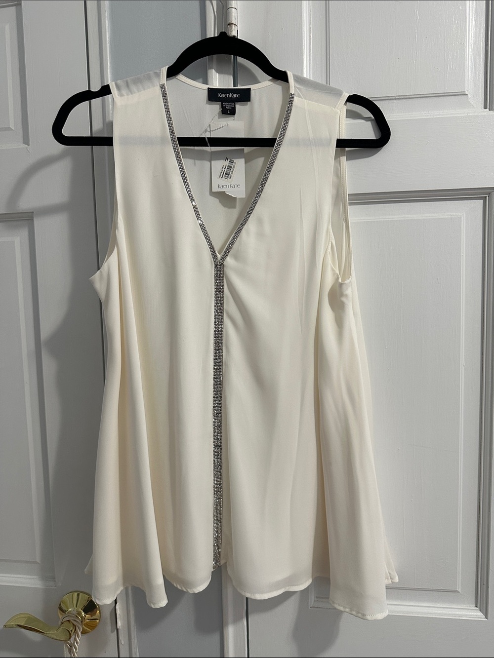 Karen Kane Cream Sleeveless V-Neck Top with rhinestone accents